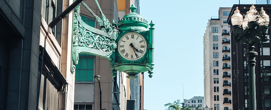 image of clock in urban city. buy vertical grow racks, grow trays, and mobile carriages for cannabis hemp grow operations
