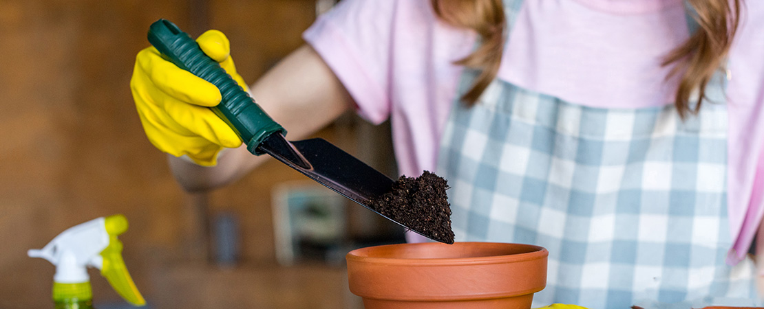 woman planting with soil